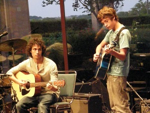 Two boys playing guitars