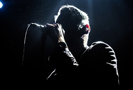 silhouette of man singing on stage